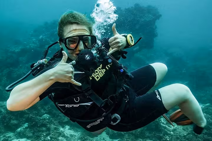 Hurghada Red Sea scuba diver giving shaka sign underwater on a sea trip tour with lunch and hotel transfer included