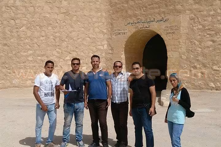Hurghada day trip group photo at Saint Paul the Anchorite Monastery entrance in the Eastern Desert