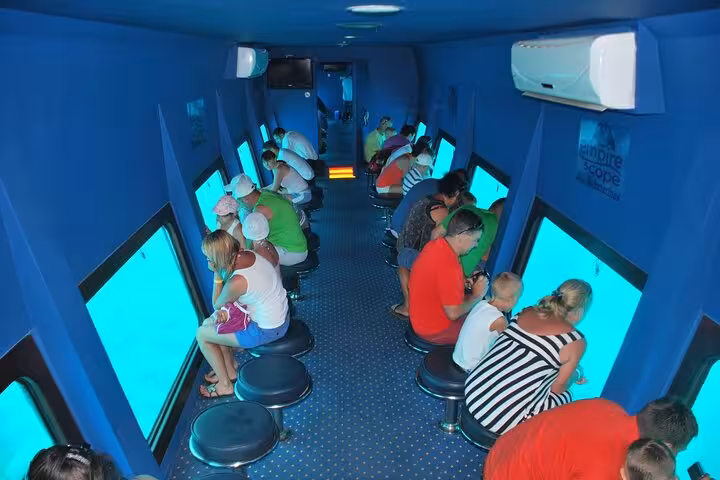 Passengers seated inside Hurghada semi-submarine cabin with large windows to watch Red Sea marine life