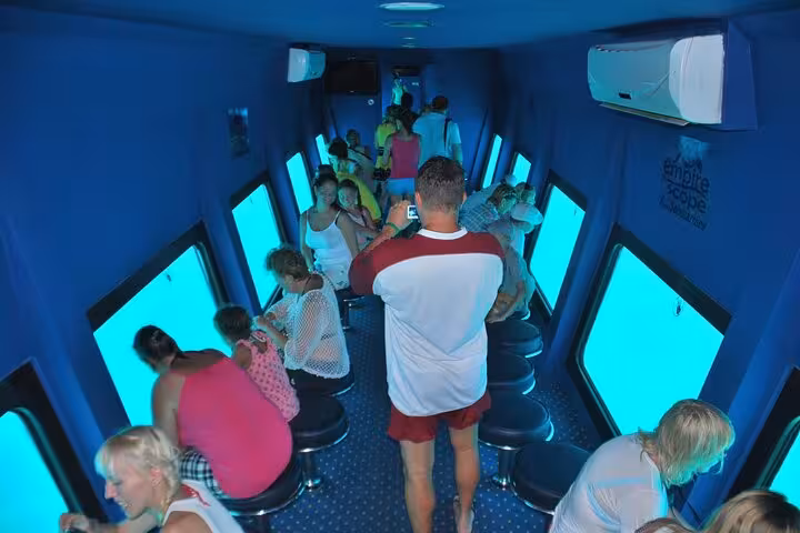Tourists taking photos inside Hurghada semi-submarine viewing deck before snorkeling in the Red Sea