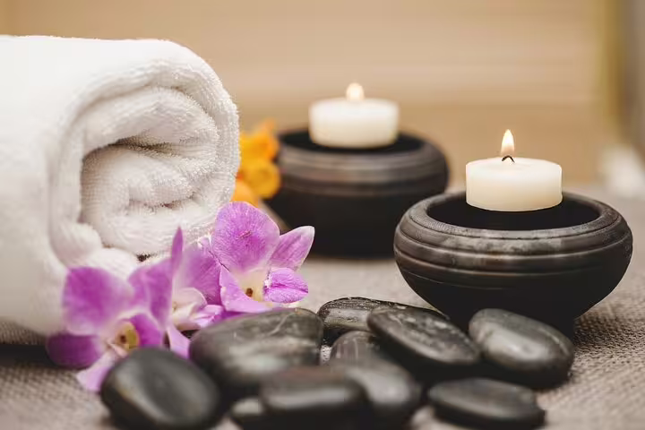 Spa still life with hot stones, candles and towel, ideal for Hurghada VIP full body massage with Jacuzzi and sauna