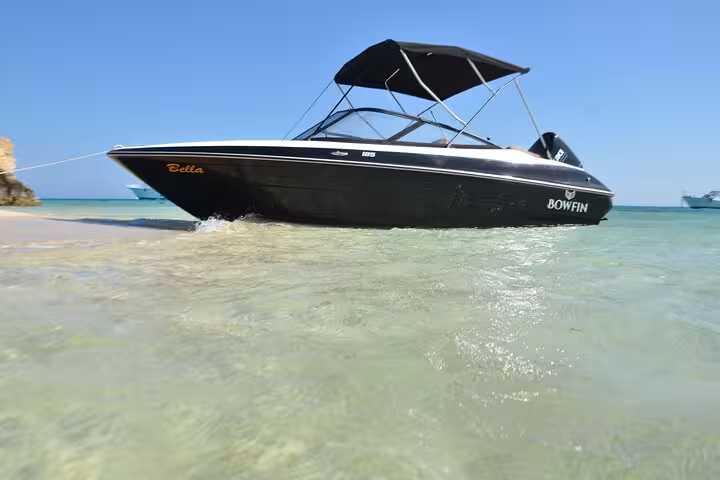 Hurghada private speedboat in shallow turquoise water, heading to Hula Hula Island with snorkeling adventure