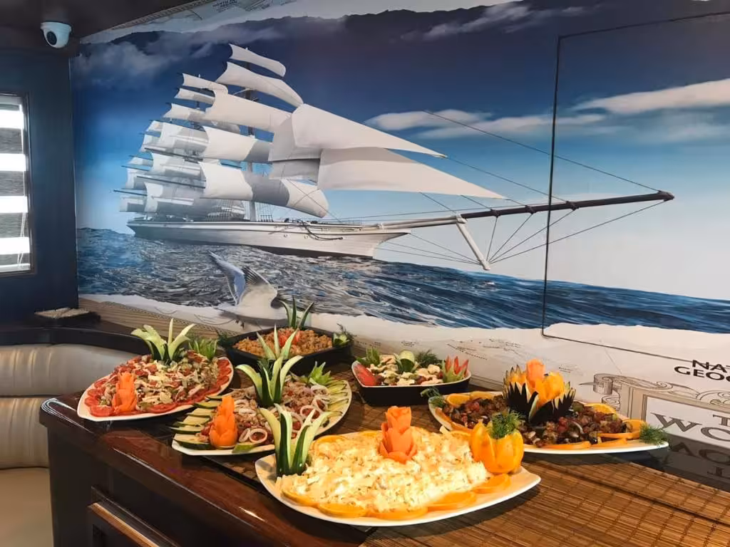 Colorful mezze dishes and salads displayed on a table inside a nautical-themed restaurant in Hurghada