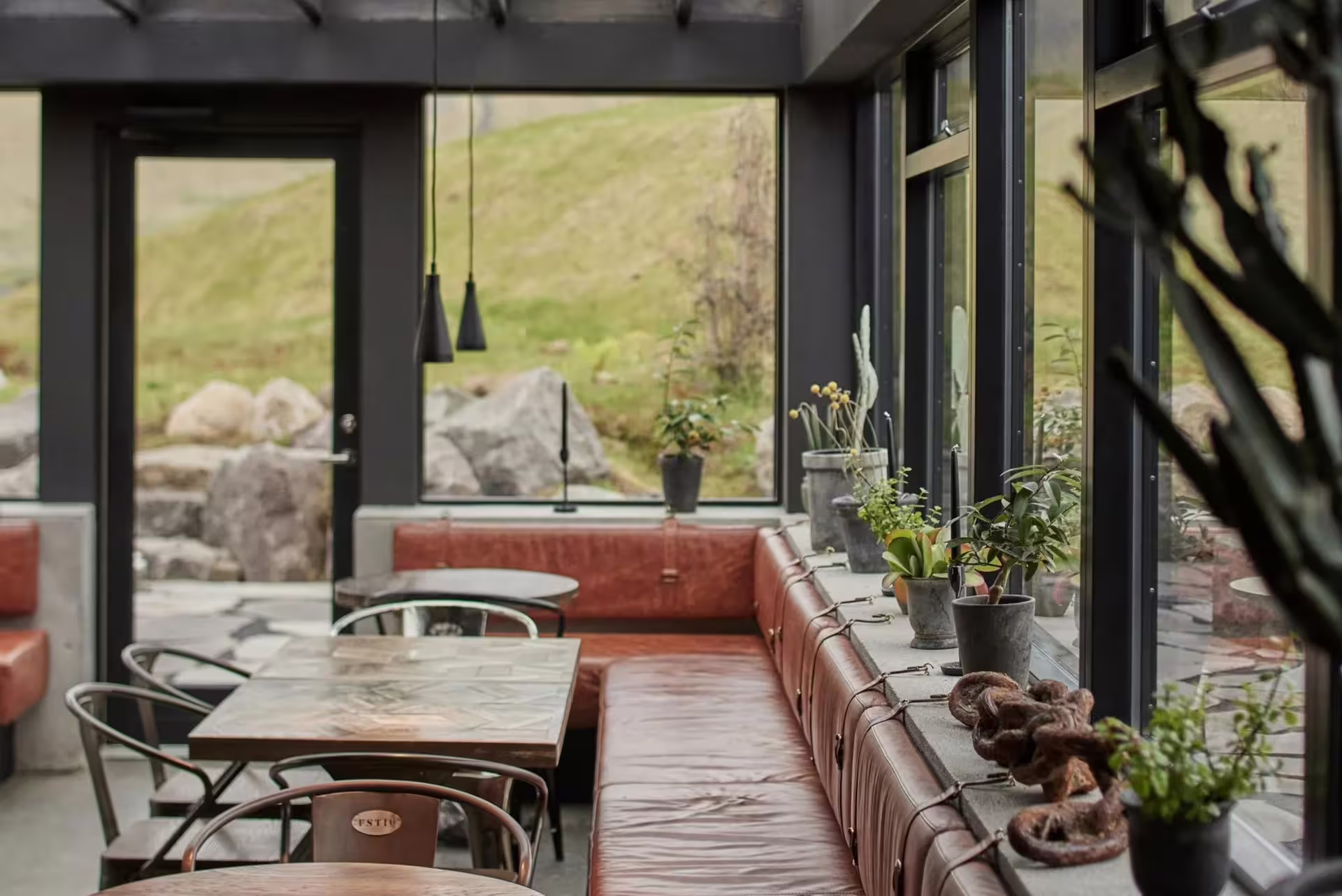 Cafe seating at Hvammsvik Hot Springs with hillside views, ideal break on a private Golden Circle tour Iceland