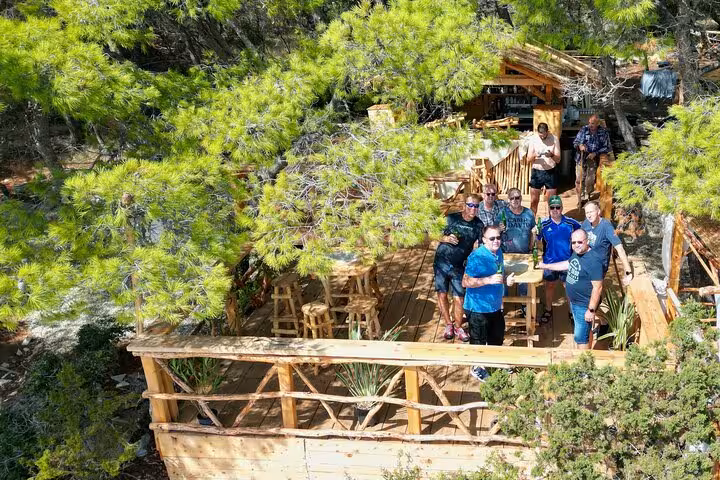Group relaxing on a rustic pine-shaded terrace on Hvar north shore, part of Golden Horn private boat tour