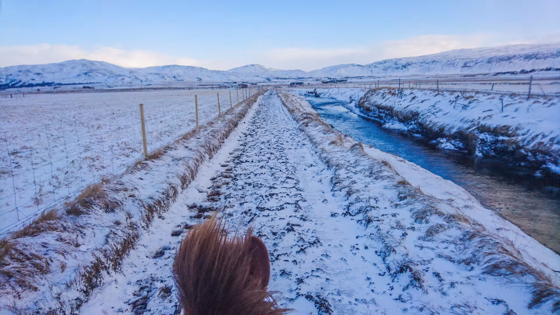 Snowy riverside trail through open meadows with distant mountains, scenic “03A - Meadows and Mountains” ride