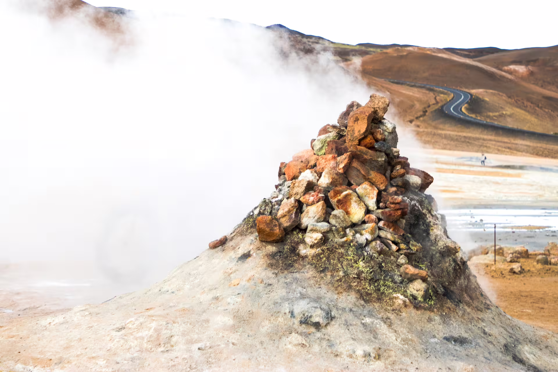 Steaming geothermal rock cairn at Hverir mud pools on Diamond Circle tour in North Iceland