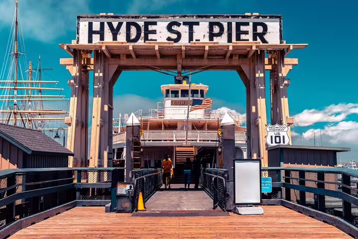 Hyde Street Pier entrance with historic ferry boat and Redwood Highway 101 sign in San Francisco