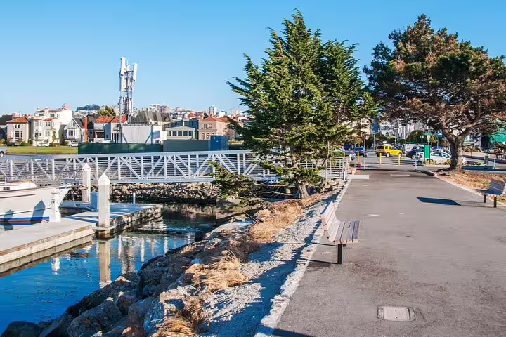 Waterfront walkway with bench near marina bridge at Hyde Street Pier, San Francisco
