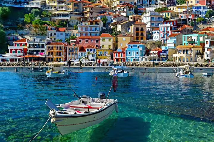 Hydra island waterfront with colorful houses and fishing boat, scenic stop on Argolis private full-day tour