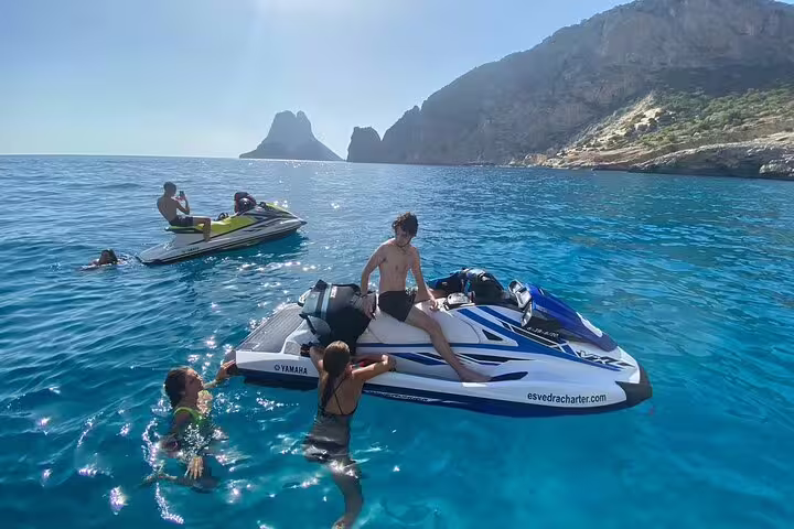 Ibiza Atlantis jet ski tour from San Antonio with swim stop, riders relaxing on jet skis in blue sea