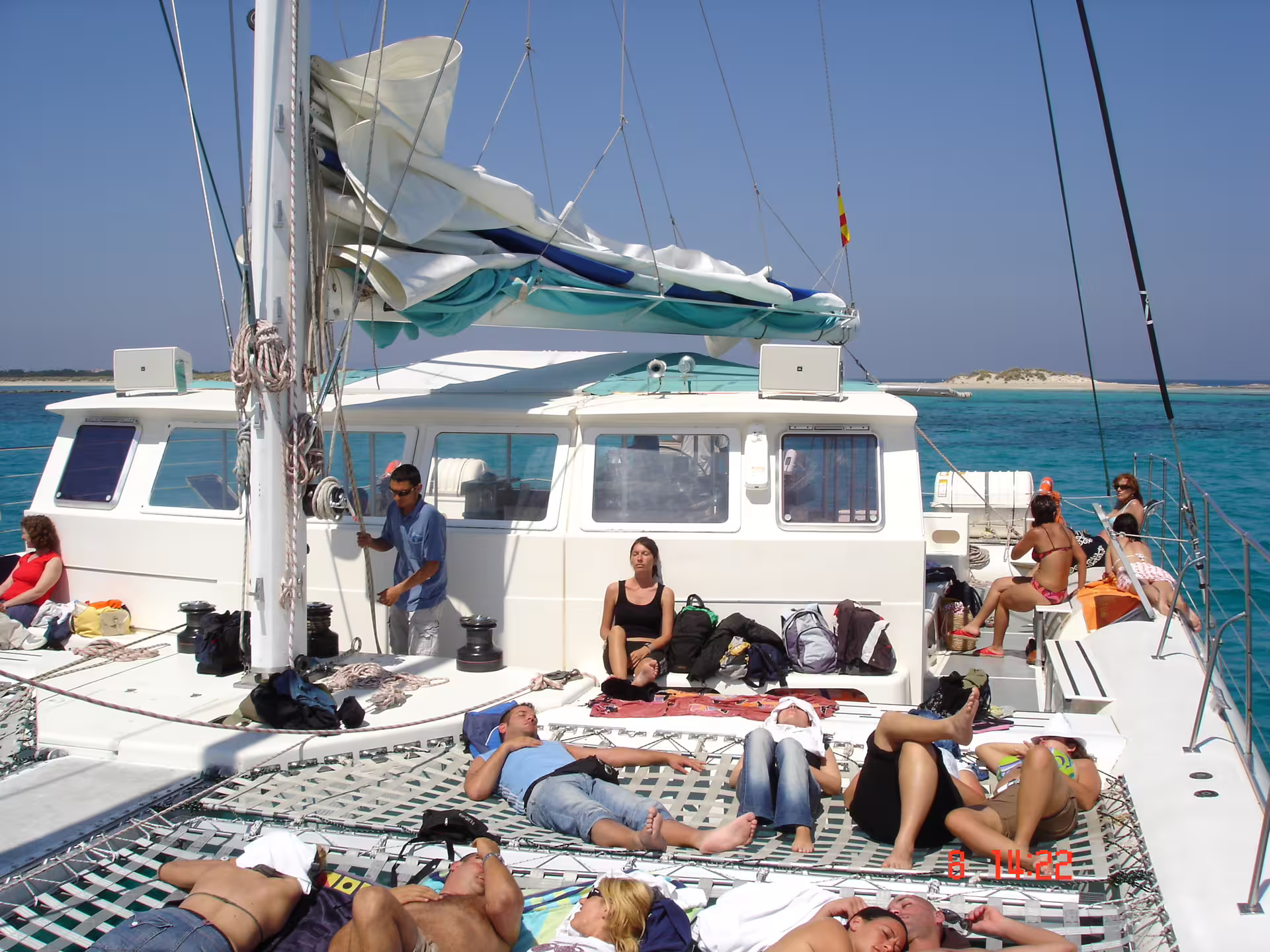 Relaxing on Ibiza catamaran to Illetas, Formentera, with turquoise sea views and onboard lunch included