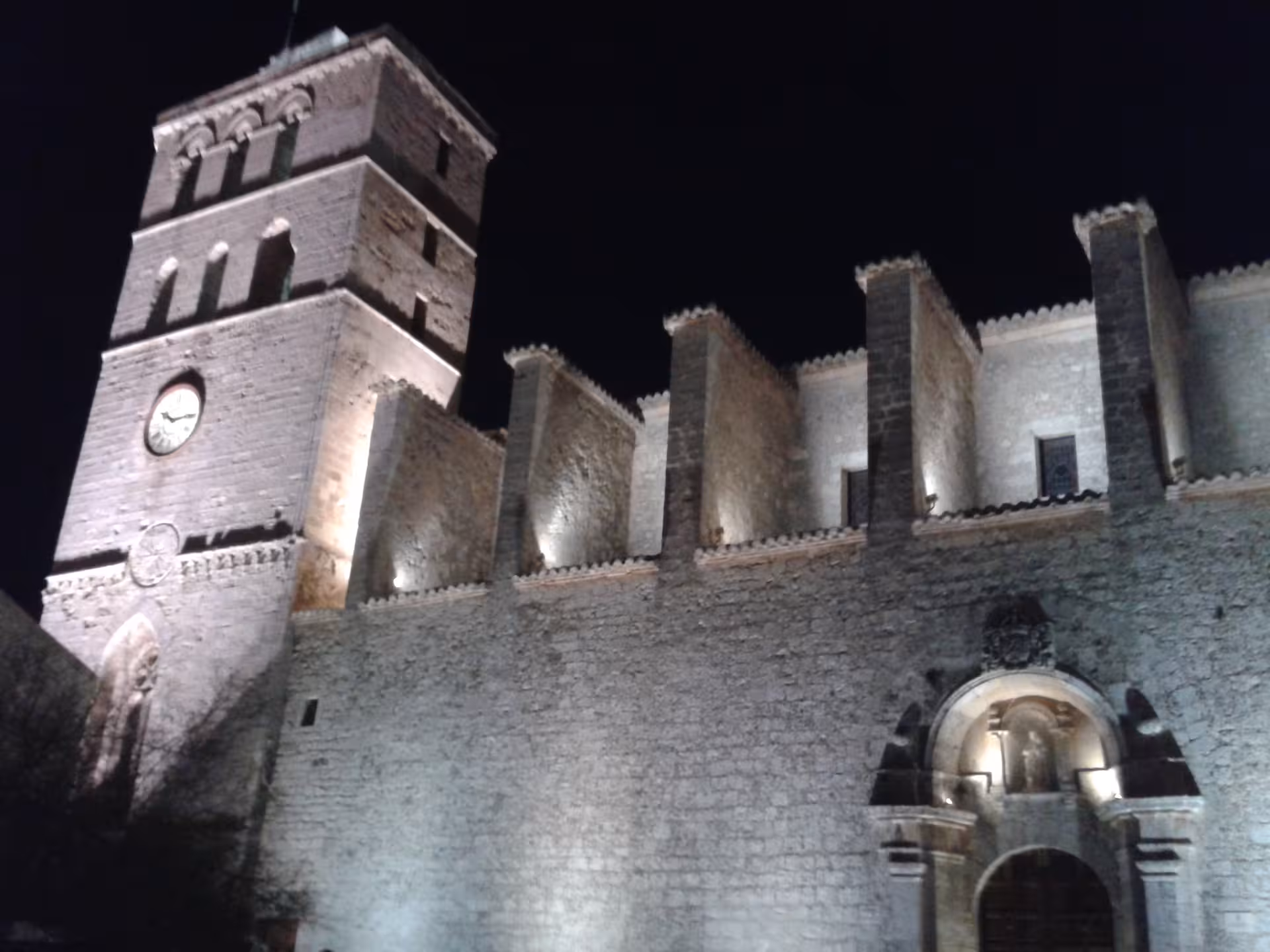 Illuminated Dalt Vila cathedral and fortress walls at night in Ibiza Old Town on official guided tour