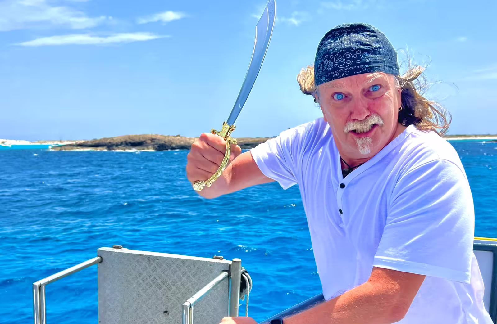 Crew member entertaining on Ibiza to Illetas Beach Formentera cruise, paella cooked onboard and drinks