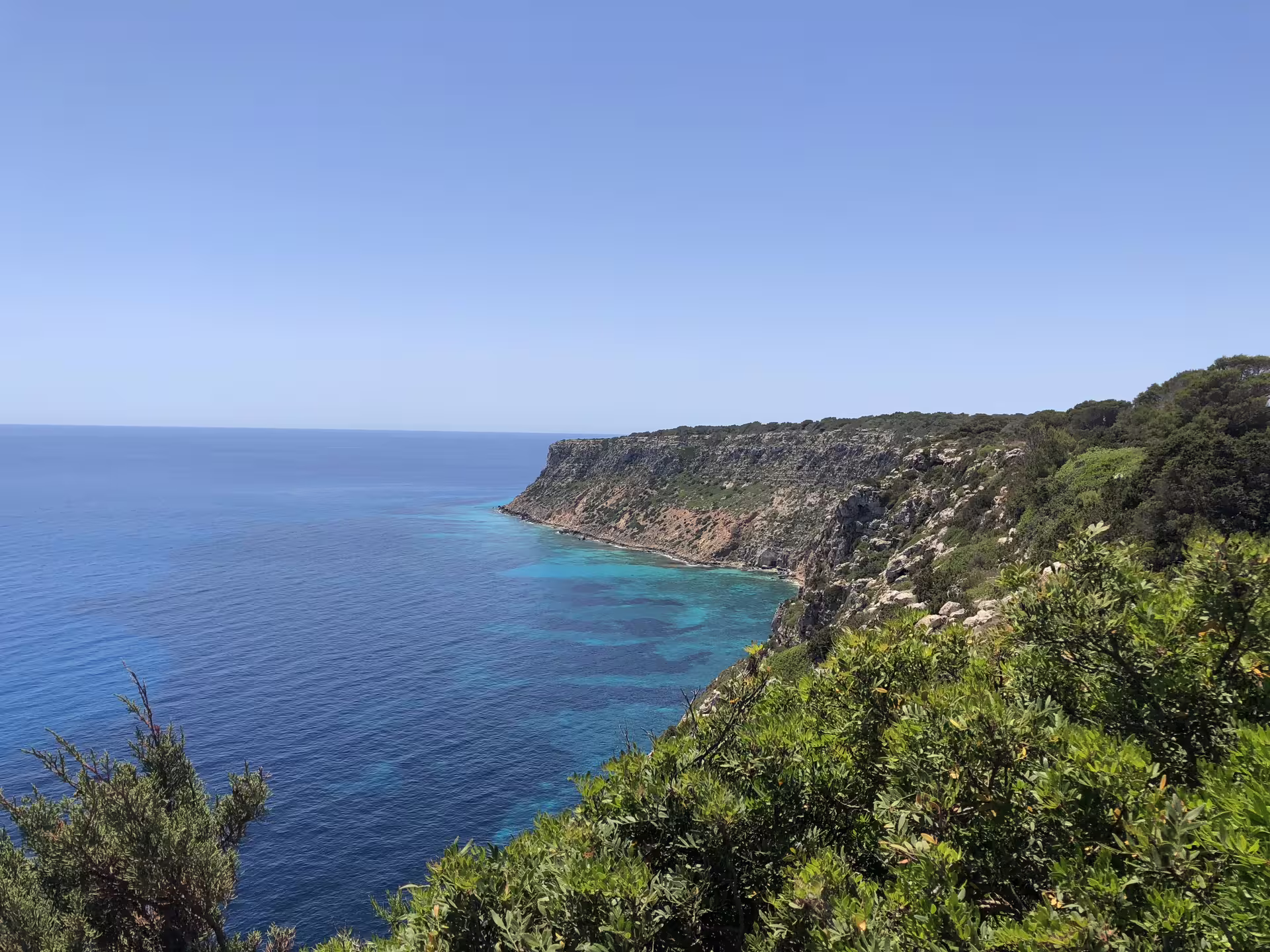 Scenic Formentera coastal cliffs and crystal-clear coves, highlight of Ibiza day trip with fast ferry and transfers