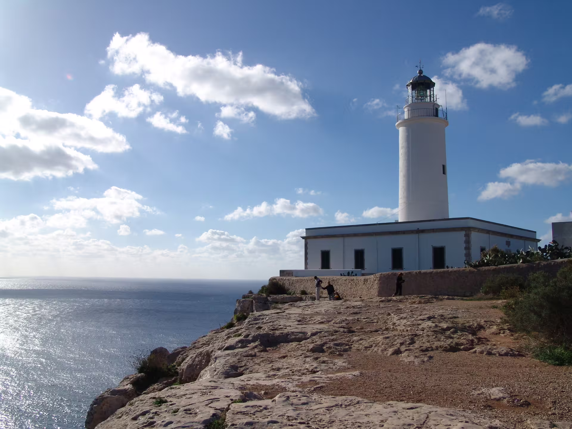 Ibiza cliffside lighthouse overlooking the Mediterranean, a scenic stop on the bus tour with fast ferry