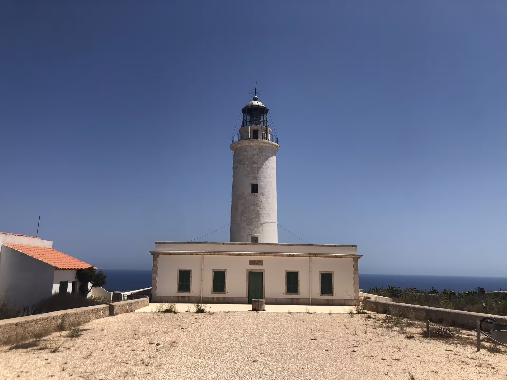 White coastal lighthouse viewpoint in Ibiza, featured on the Ibiza bus tour with fast ferry and official guide