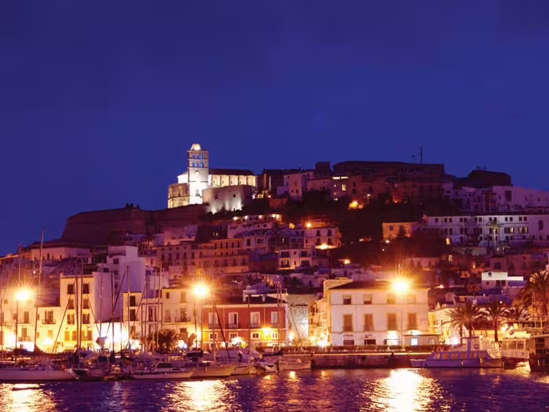 Ibiza Town port at night with marina lights and Dalt Vila skyline, ideal stop on Ibiza Night transfer tour