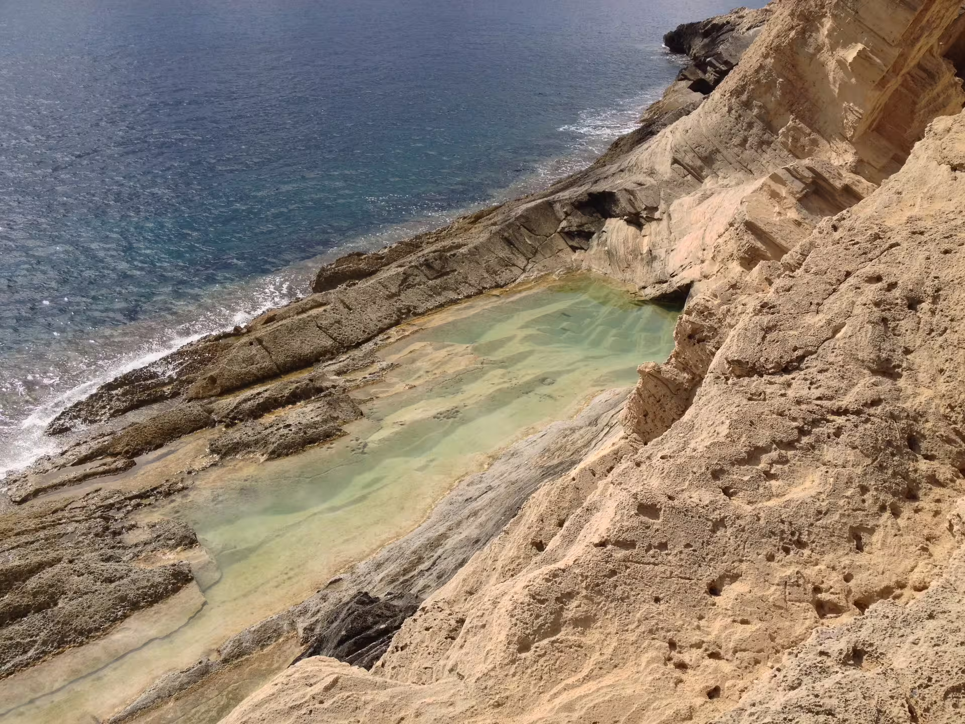 Rocky Ibiza coastline natural pool stop on Es Vedrà sea excursion from San Antonio with guide, drinks