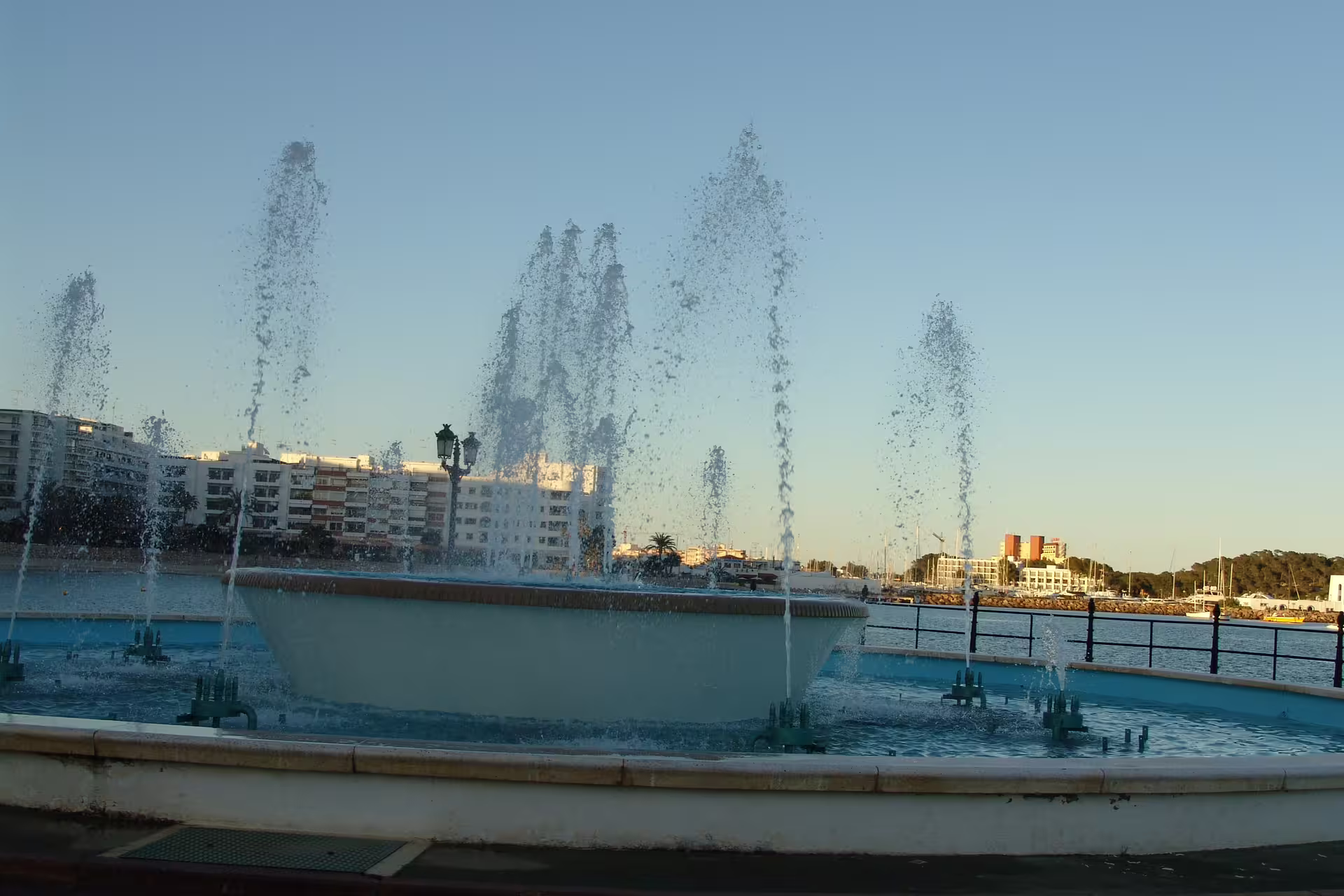 Ibiza Town waterfront fountain at sunset by the marina, a highlight stop on the Ibiza bus island tour with guide