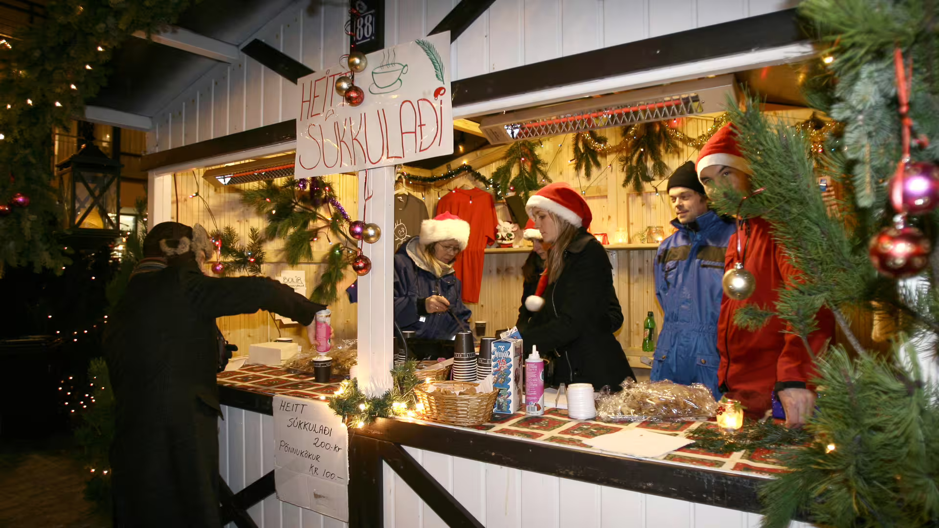 Icelandic Christmas market stall selling heitt súkkulaði hot chocolate, decorated with festive garlands and ornaments