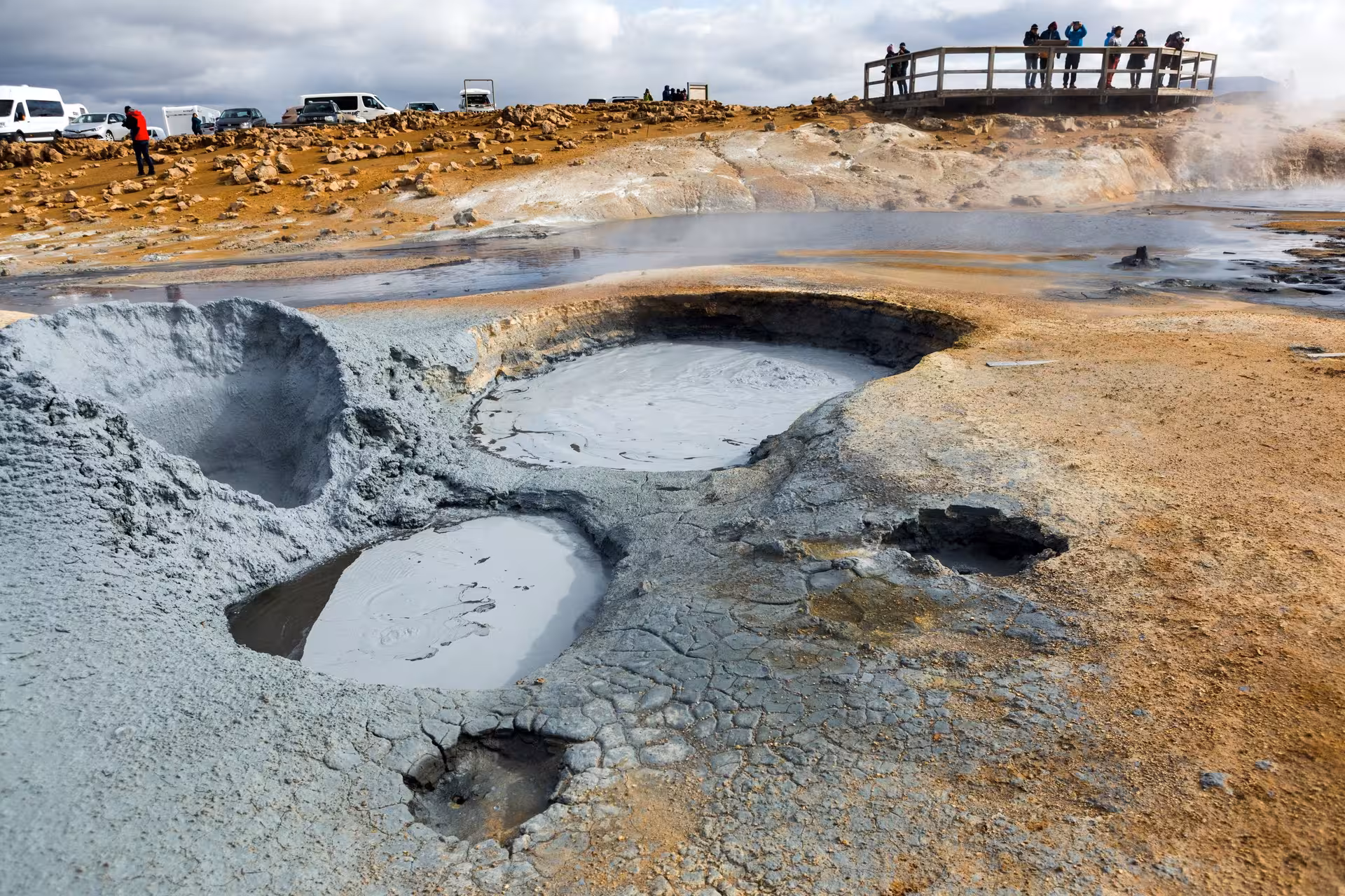 Explore Iceland's geothermal wonders at Hverir, featuring bubbling mud pots and steaming fumaroles on a 9-day self-drive tour.