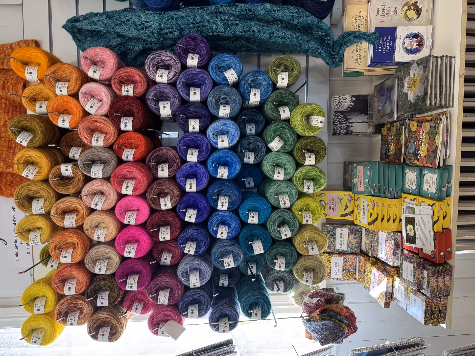 Colorful skeins of yarn displayed in Icelandic shop, ideal for creative inspiration on knitting tour.