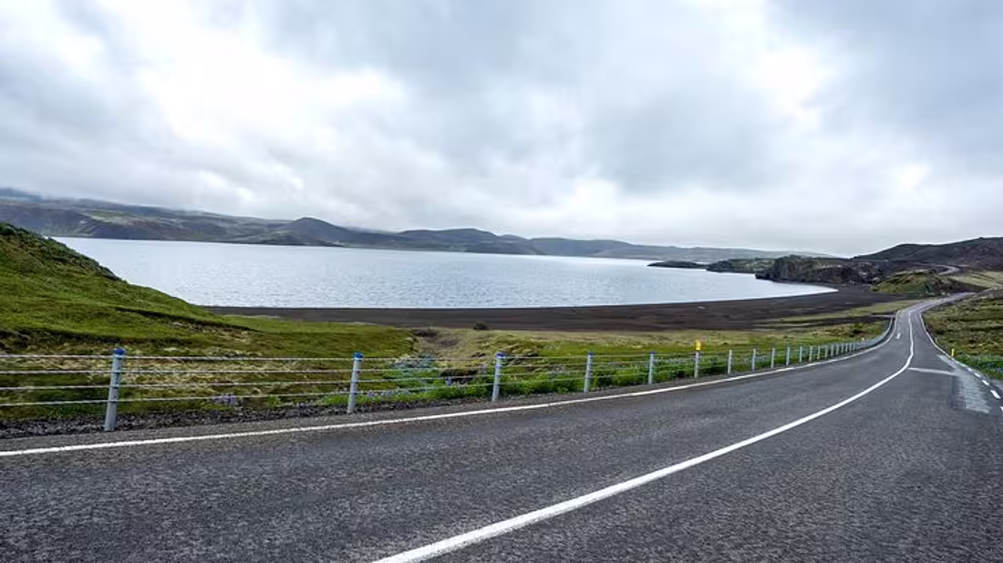A stretch of road beside a fjord in Iceland