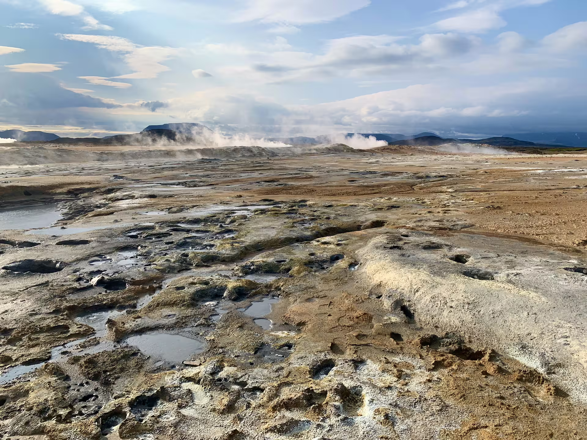 Steaming geothermal landscape with mud pools and volcanic terrain on a private super jeep tour in Iceland