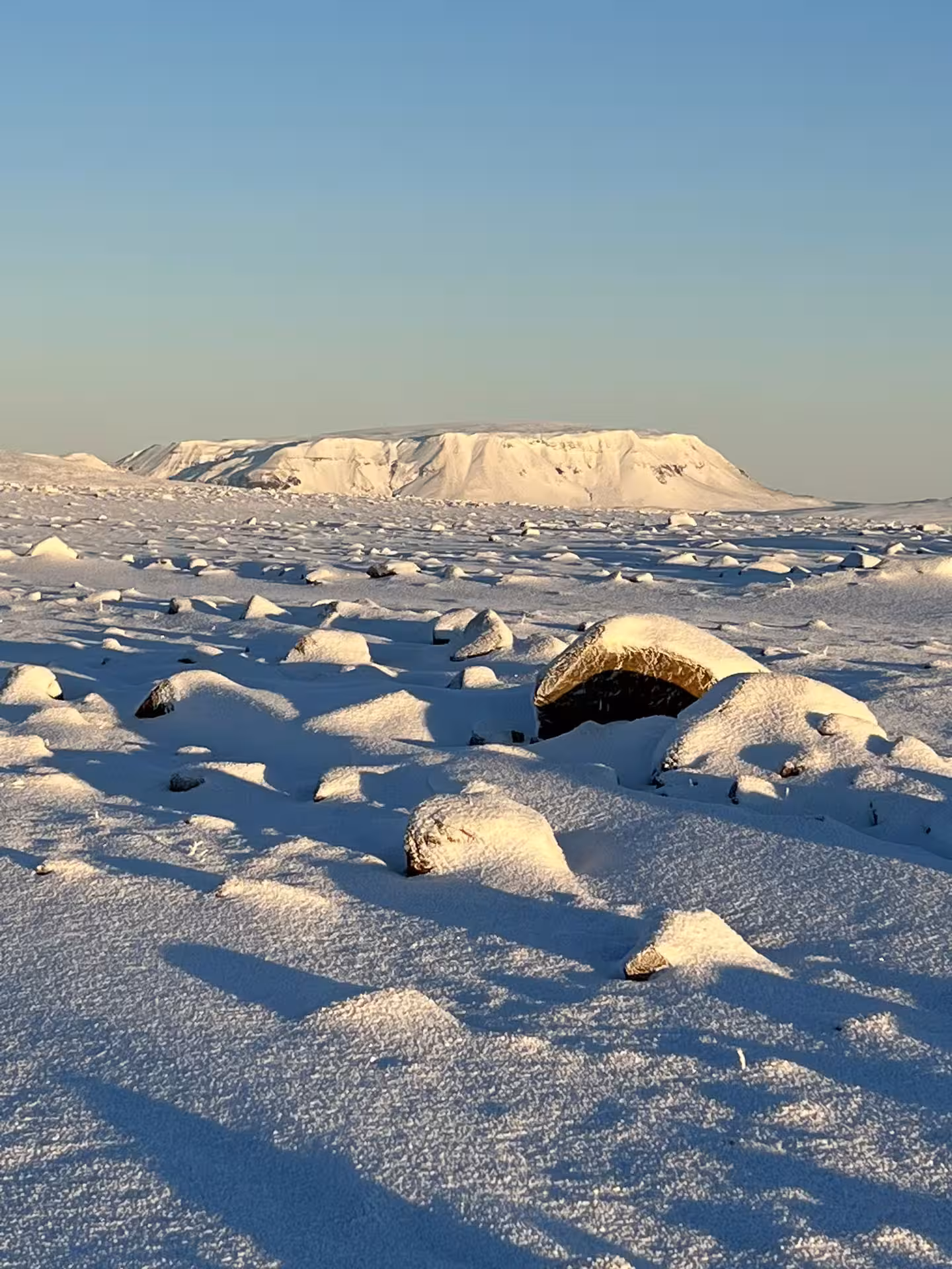 Snow-covered rocky glacier landscape under blue sky on Iceland Golden Circle Super Jeep tour