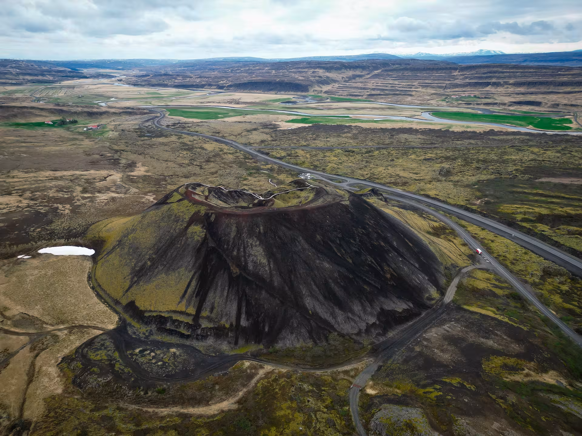 Aerial view of a volcanic crater cone along Iceland's Golden Circle road through lava fields