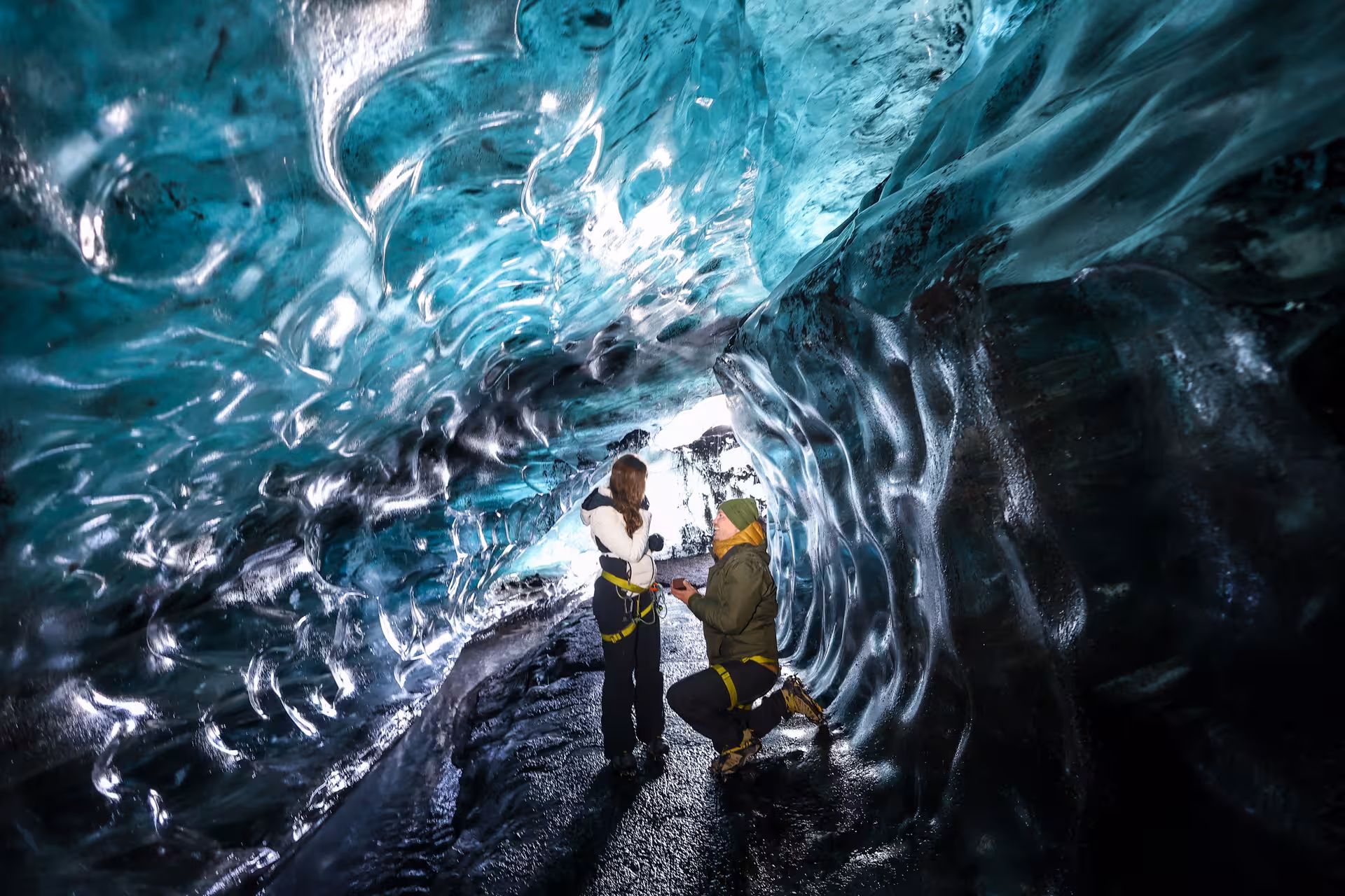Magical Iceland ice cave proposal with couple surrounded by stunning blue glacial crystal formations Vatnajokull