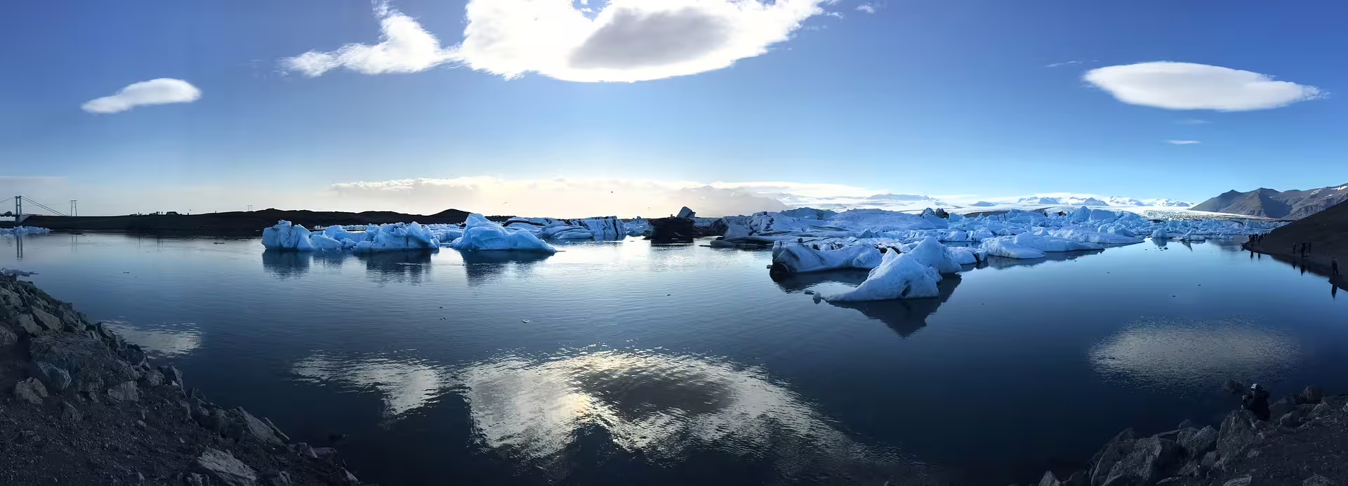 Icebergs floating on the calm blue waters of Jökulsárlón glacier lagoon in Iceland under a clear sky