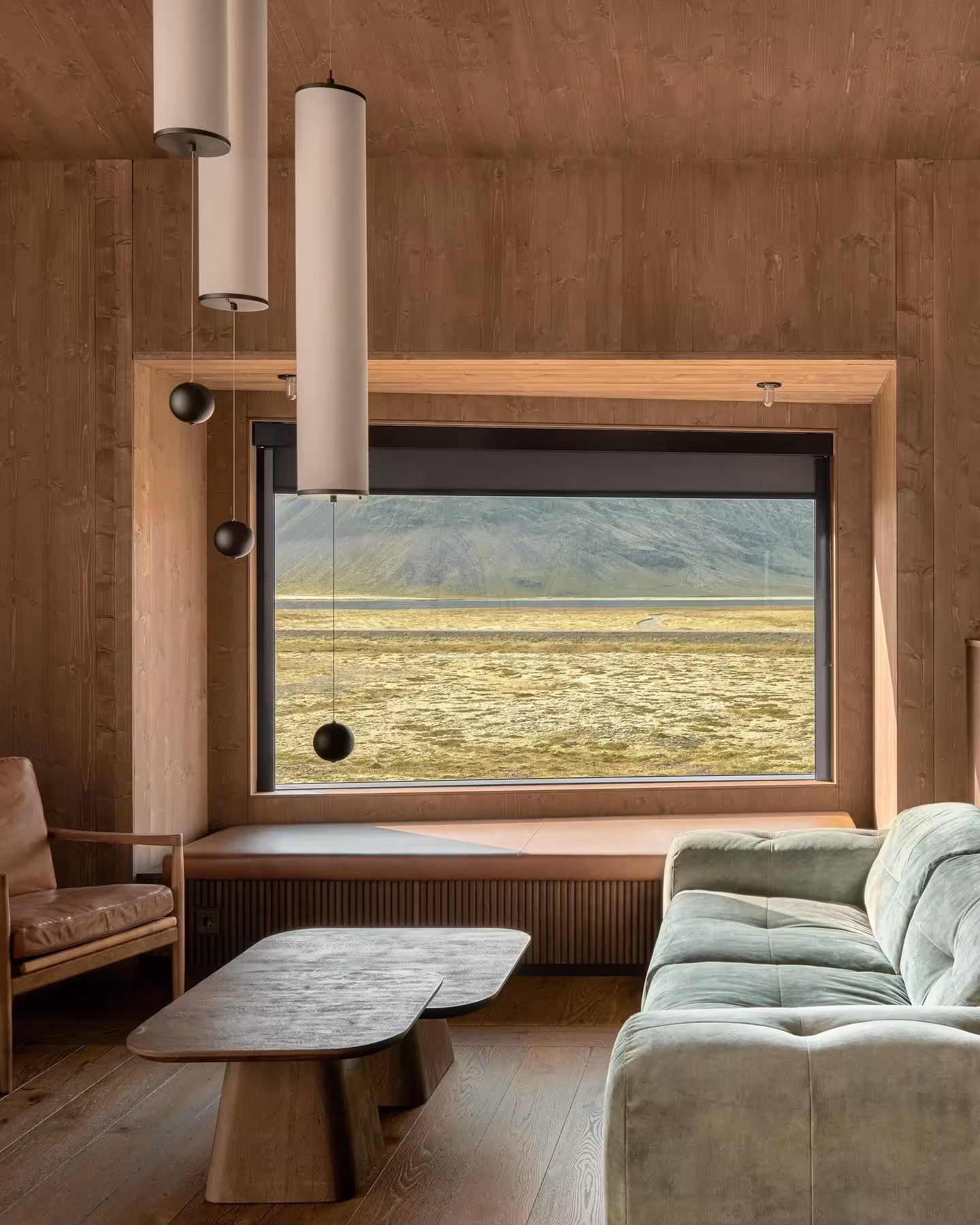 Cozy Iceland lodge interior with panoramic window overlooking vast lava fields near Glacier Lagoon proposal tour