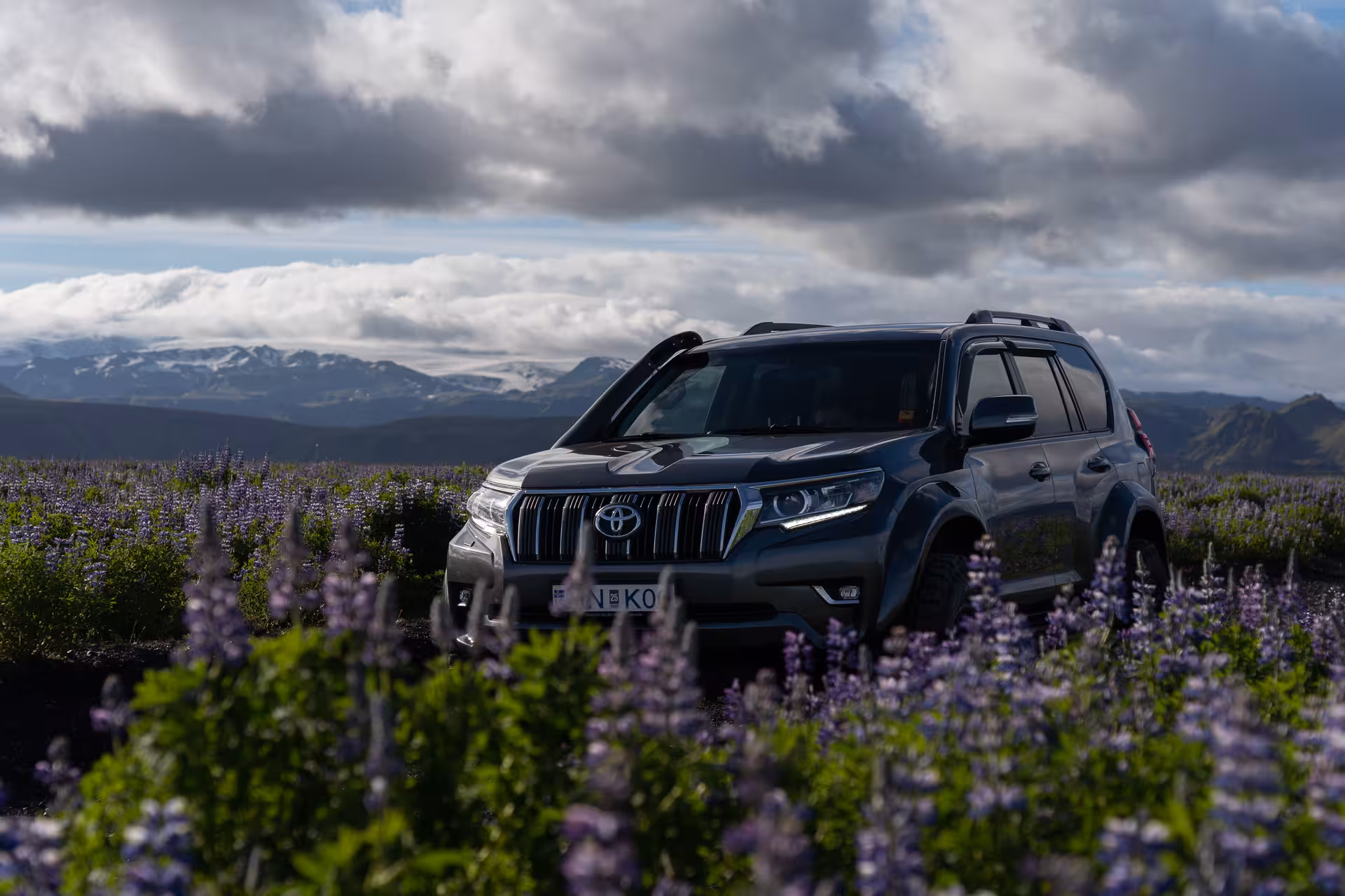 4x4 tour vehicle crossing Iceland South Coast landscapes before Sólheimajökull glacier hike experience
