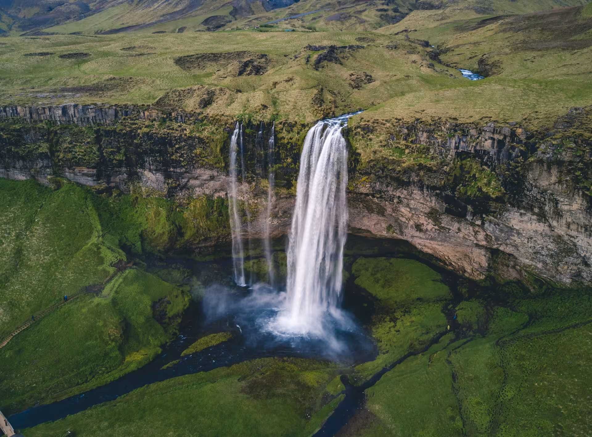 Aerial view of Seljalandsfoss waterfall cascading over green cliffs in Iceland