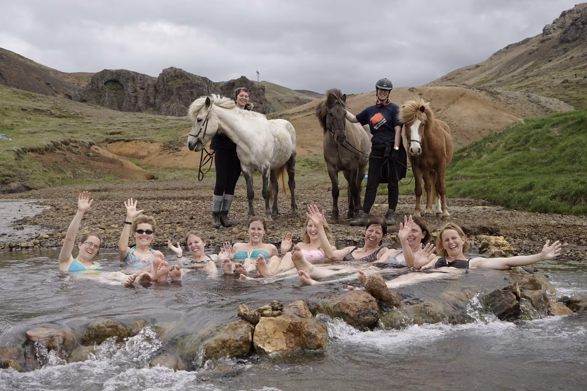 Guests relaxing in a natural hot spring river after Icelandic horse ride on 05A Hot Springs Tour in Iceland