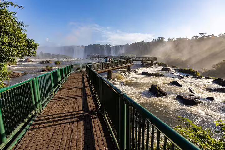 Scenic walkway overlooking the majestic Iguazu Falls, a must-see destination on the 4-day guided tour itinerary.