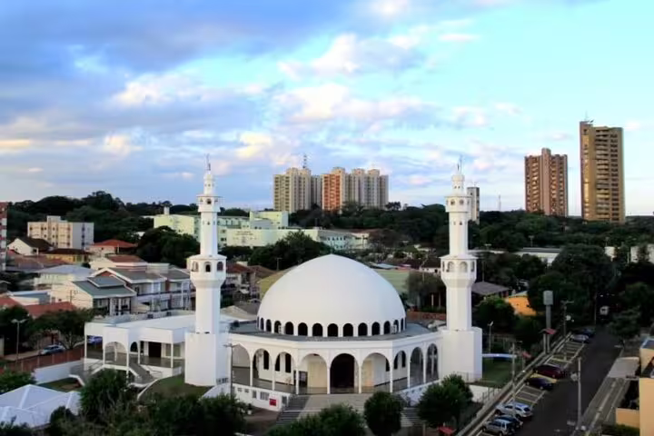 Scenic view of a white domed mosque surrounded by cityscape in Foz do Iguaçu, part of the Iguazu Falls tour.