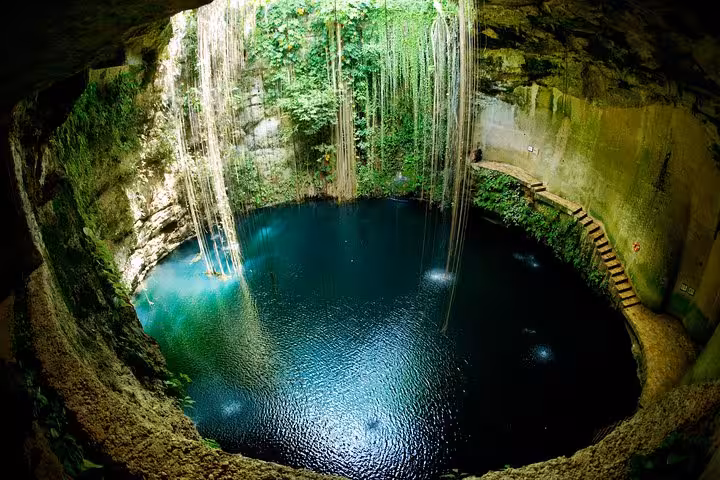 Stunning aerial view of Ik Kil Cenote with crystal-clear turquoise water and hanging vines in Yucatan Mexico