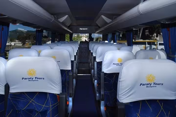 Comfortable interior of a shuttle bus by Paraty Tours, providing shared transfers from Ilha Grande to Paraty.