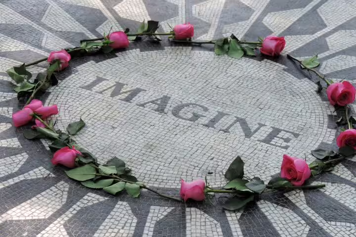 Pink roses arranged in a circle around the Imagine mosaic at Strawberry Fields, Central Park NYC