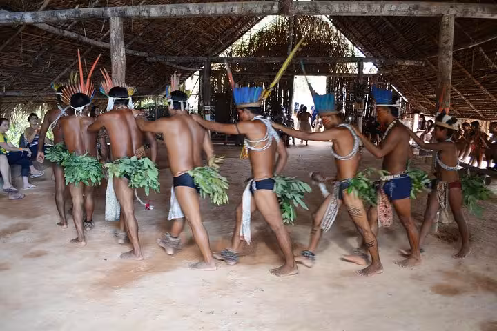 Indigenous dance inside Amazon maloca on Indian Village and Meeting of the Waters tour near Manaus