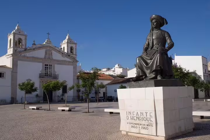 Statue of Infante D. Henrique in Lagos, Portugal, featuring historical architecture, part of a full-day tour to Benagil and Lagos.