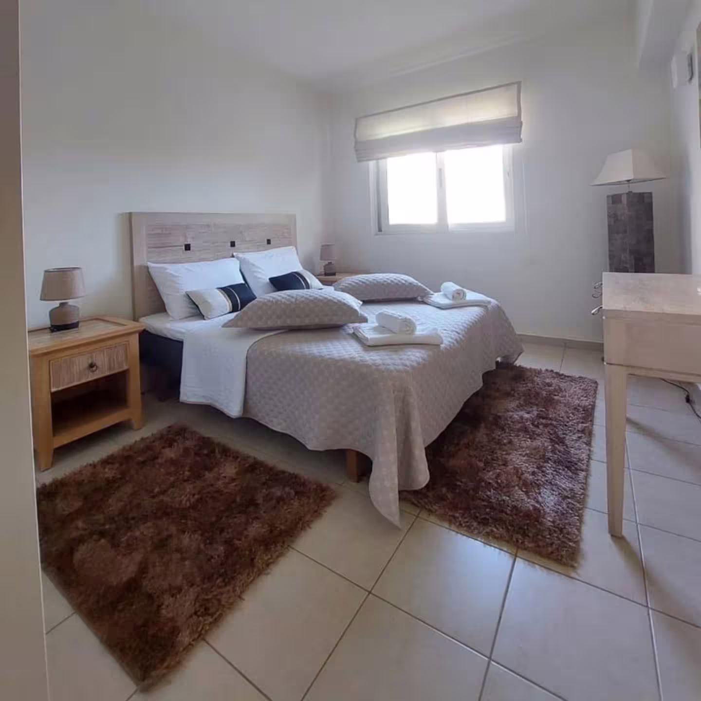 Cozy bedroom at Infinity Night Villa with plush bedding, natural light, and elegant decor for a serene private stay.