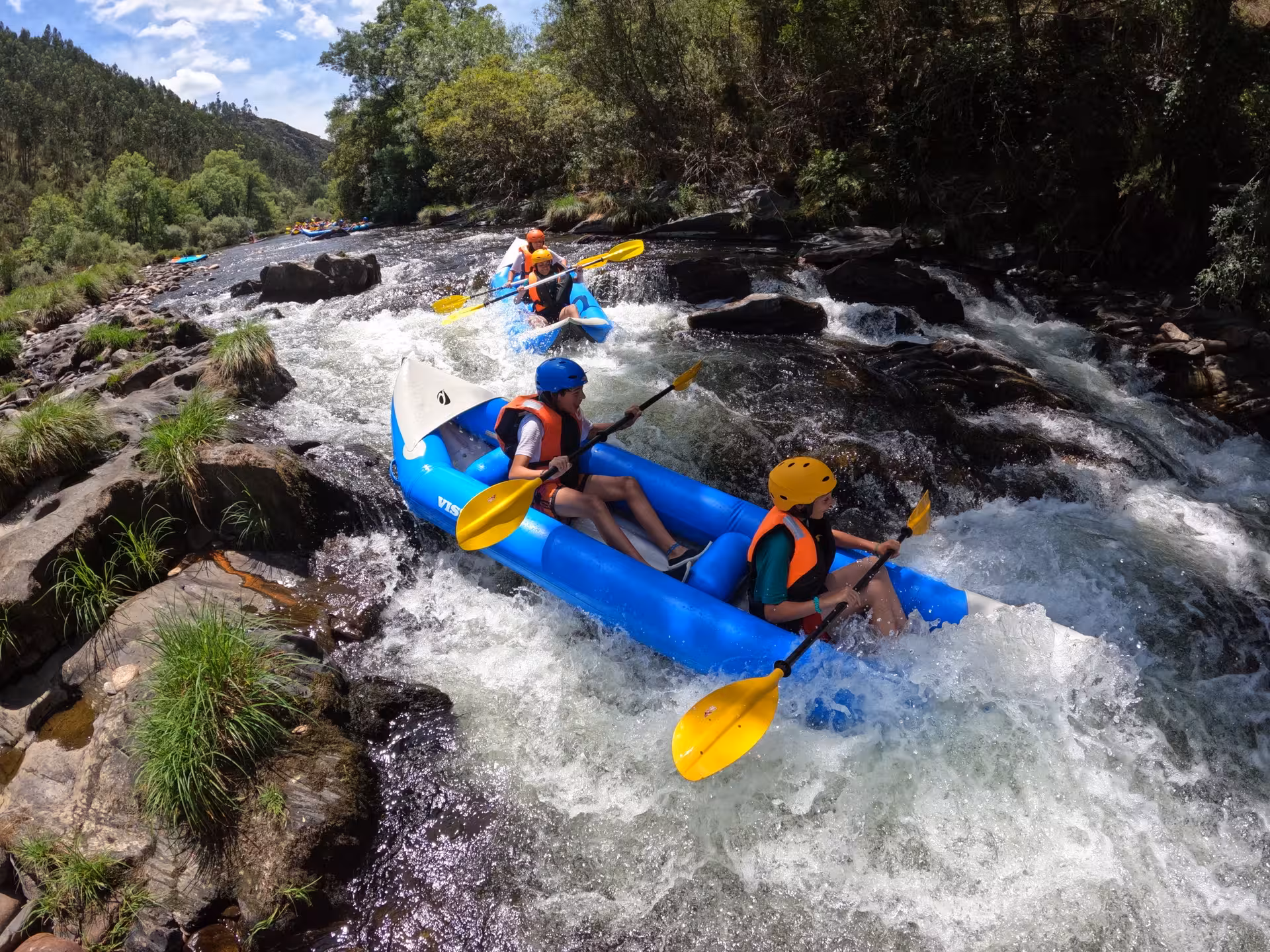 Inflatable canoe drops into Paiva River rapids in Arouca Geopark, Portugal, thrilling canyon adventure