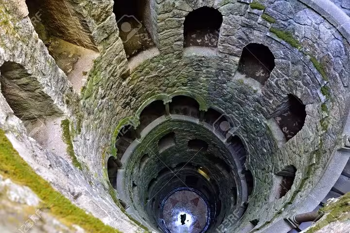 Mysterious Initiation Well at Quinta da Regaleira in Sintra, revealing its spiral staircase and intricate stonework.