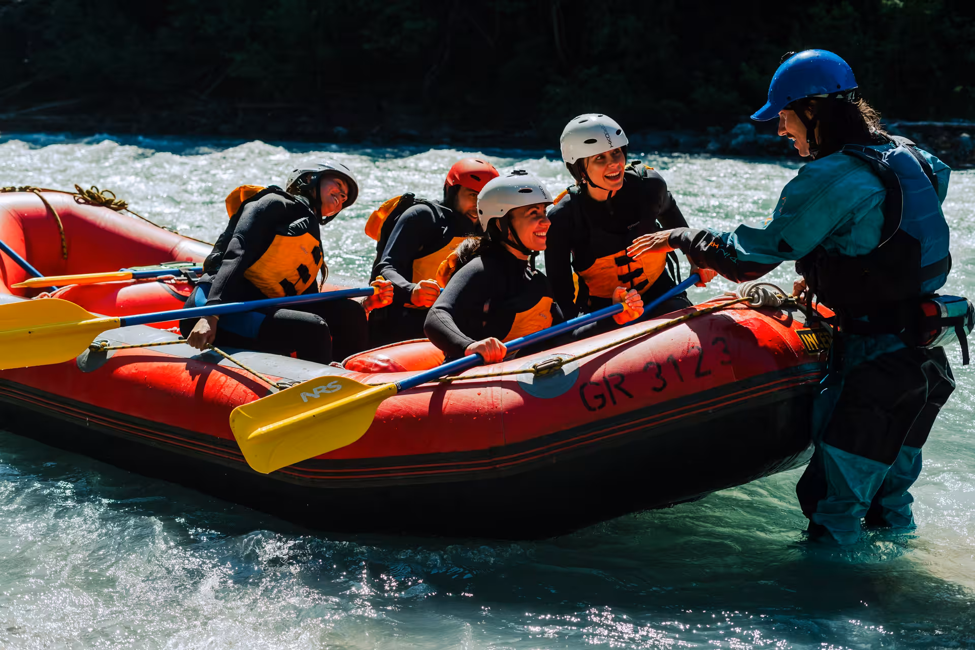 Group enjoying thrilling rafting adventure on Interlaken's whitewater rapids with expert guide.