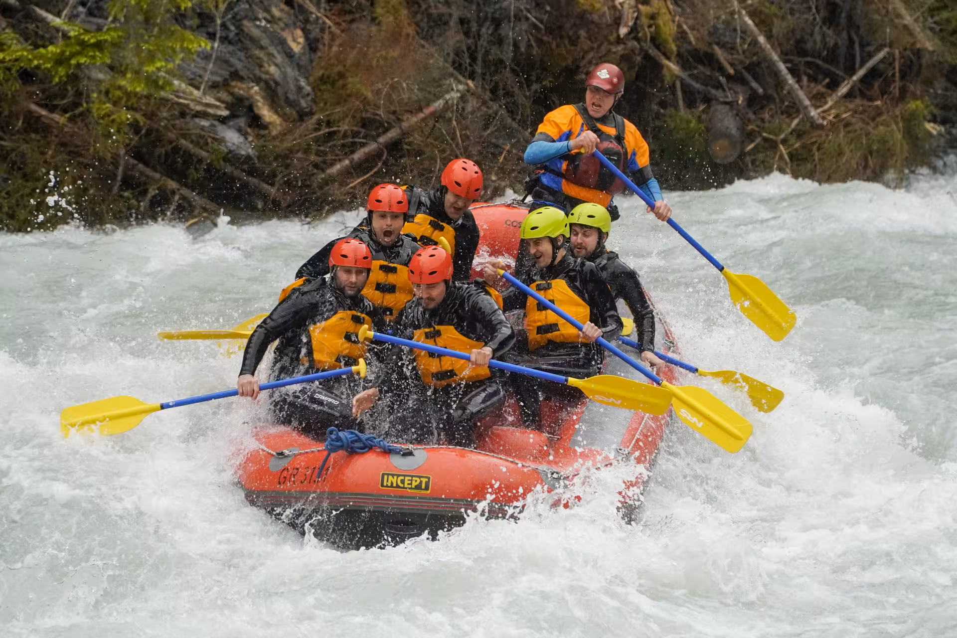 Excited rafters navigating turbulent whitewater rapids on an adventurous Interlaken rafting tour in Switzerland.