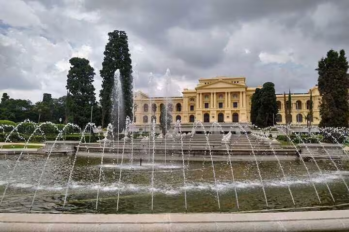 Stunning view of Ipiranga Museum's grand facade with elegant fountains and lush greenery.
